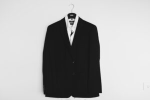 A white shirt and black business jacket on a hanger